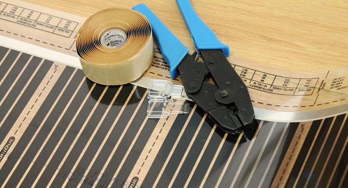 Det anbefales ikke å installere spesielle klemmer under linoleum, du kan sette varmeren på en spesiell selvklebende base